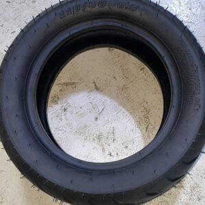 Black 110/50-6.5 SM01 tire for racing scooters with aggressive tread pattern