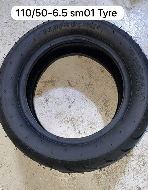 Black 110/50-6.5 SM01 tire for racing scooters with aggressive tread pattern